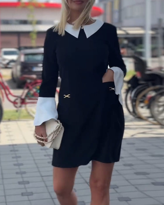 Elegantes kleid mit kontrastierendem revers und glockenärmeln